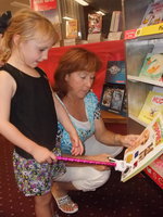 Image: What Book Do I Want? — First grade teacher Charlotte Morgan peruses the books.