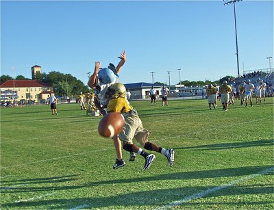 Image: How it’s done — Italy JV cornerback Eric Carson creates a midair collision causing an incomplete pass by the Cougars.