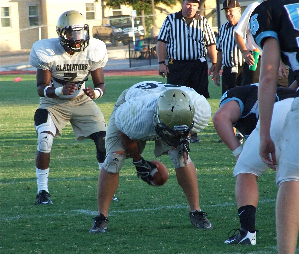 Image: Ethan snaps to Senio — Center Ethan Simon snaps to quarterback Jasenio Anderson near the Cougar goal line.