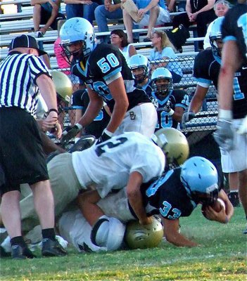 Image: Two hits better than one — Brandon Souder(62) and Kyle Wilkins make a high-low tackle on an unfortunate Cougar ball carrier.