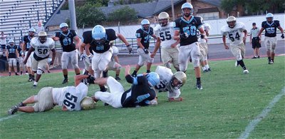 Image: We caught a Cougar — Ethan Simon(56) and Kyle Jackson(33) combine to catch a Cougar ball carrier in their trap.