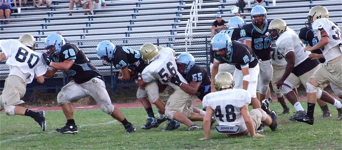 Image: Simon snags a Cougar — Linebacker Ethan Simon(56) hangs on to a Reicher runner.