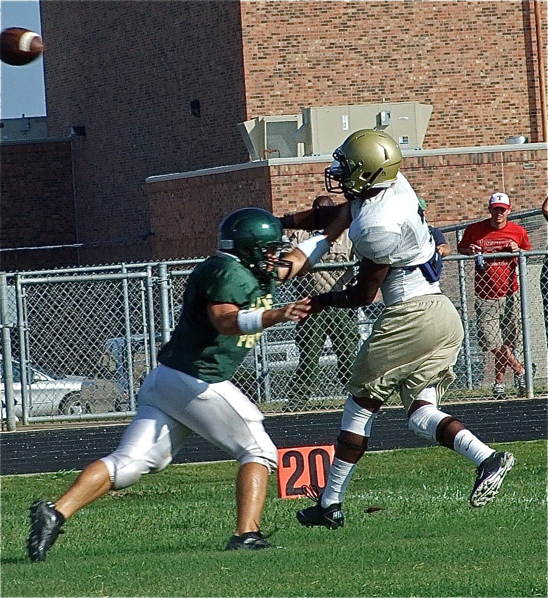 Image: A step ahead — Jasenio Anderson releases the pass before an Eagle defender can reach him.