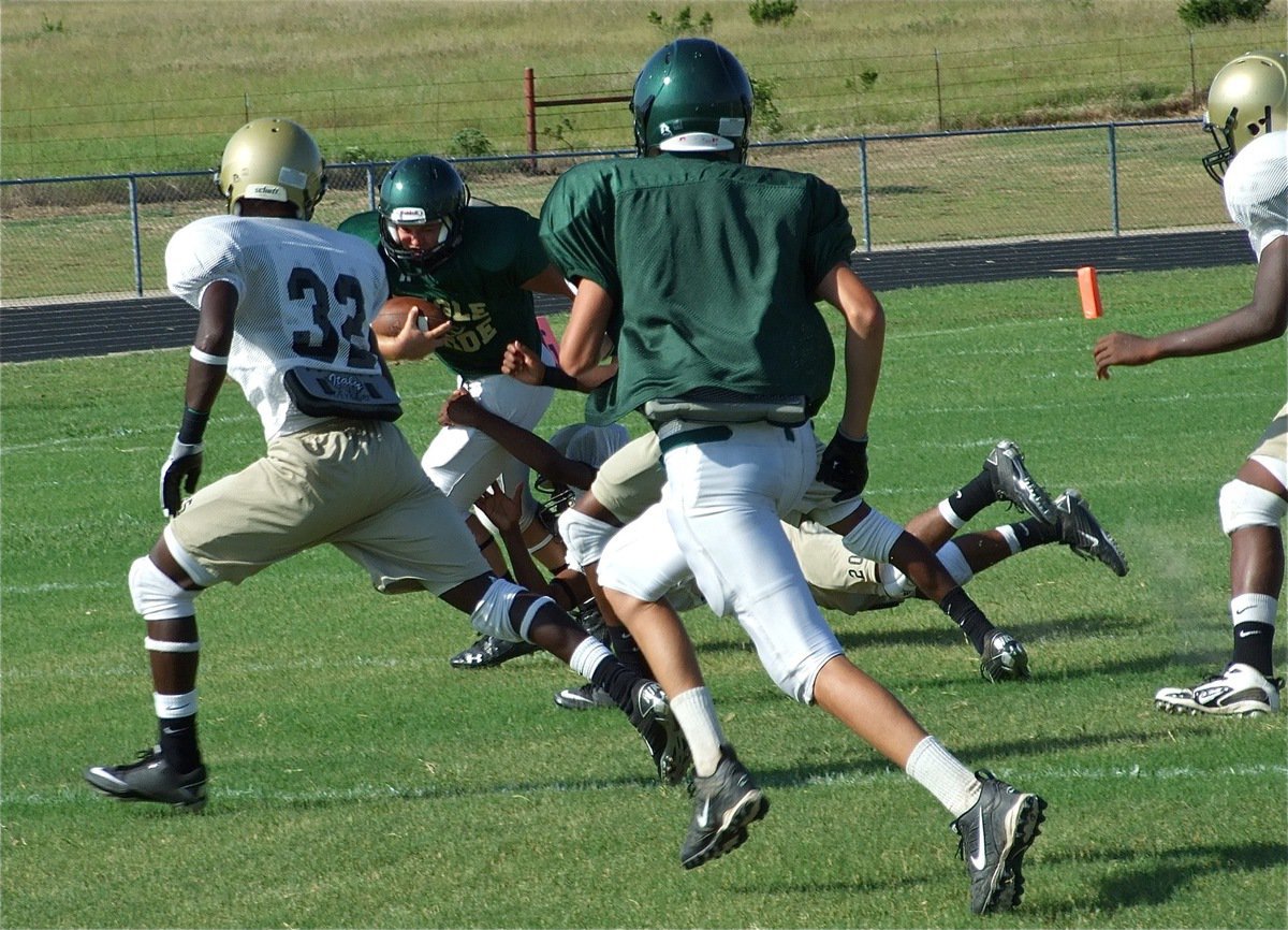 Image: No escape — Corrin Frazier(33) and Larry Mayberry pursue as De’Andre Sephus drags down an Eagle runner.