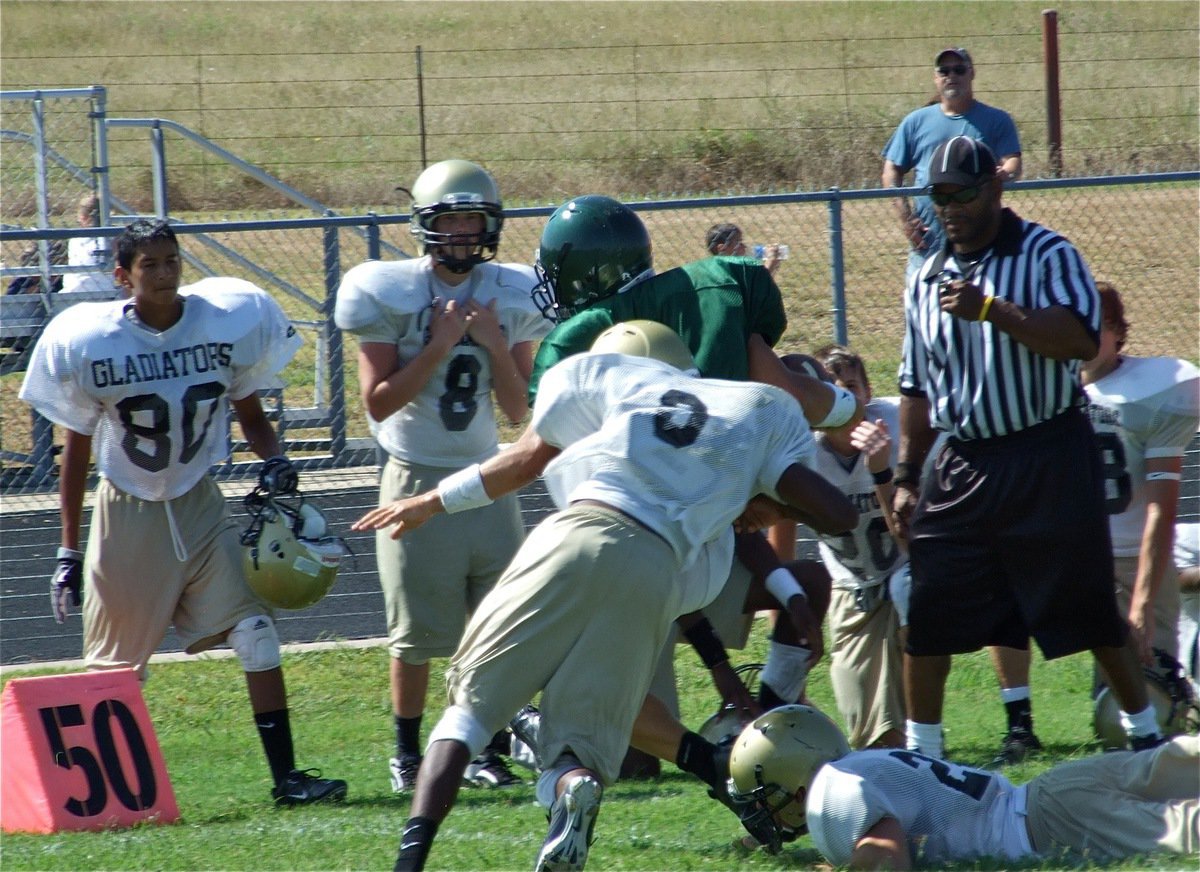 Image: Out of bounds — Gladiators’ Heath Clemons and Ethan Saxon finish off an Eagle player forcing him out of bounds.