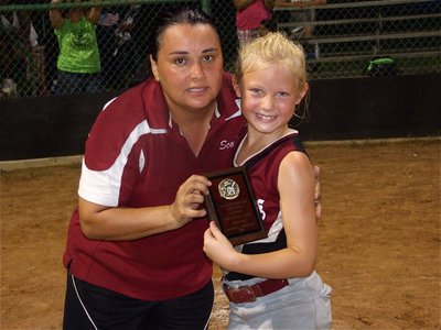 Image: Only six years old — Ferris’ second baseman Jessie Wakefield receives her district tournament Runner Up plaque from her head coach Minerva Evans.