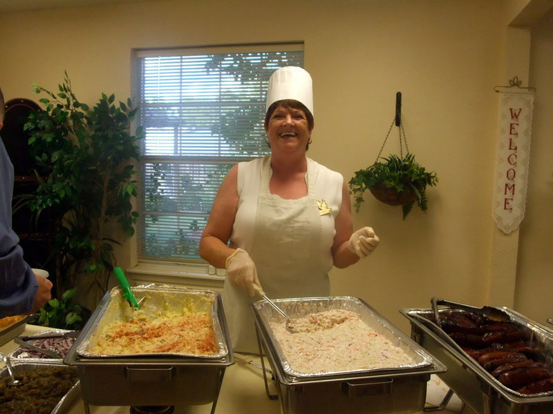 Image: Dodi Chambers — Dodi cheerfully helps serves up dinner.