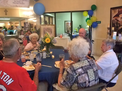 Image: Residents and Family  — Residents and friends eating together.