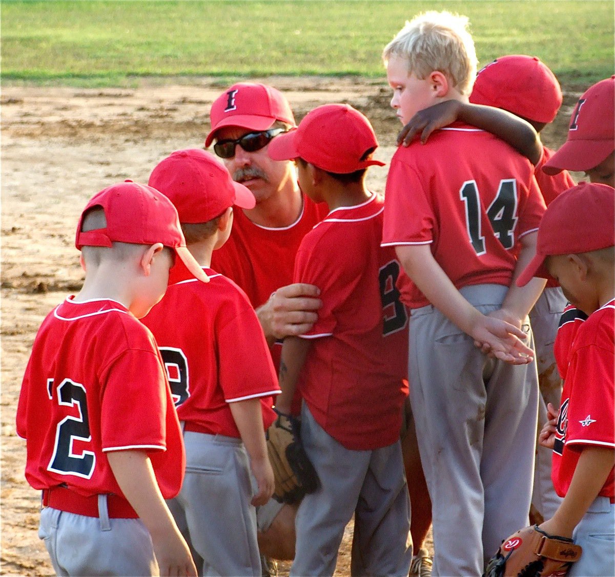 Image: “Everybody in!” — Coach Charles Hyles tries to motivate his IYAA T-Ball boys team before the division tournament championship game against Hillsboro.