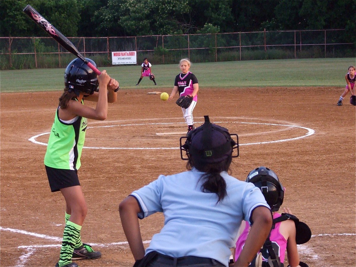 Image: Here comes the pitch — Brycelen Richards fires in a pitch to catcher Taylor Boyd with Cassidy Gage ready at second base and Elizabeth Garcia is all set in centerfield.