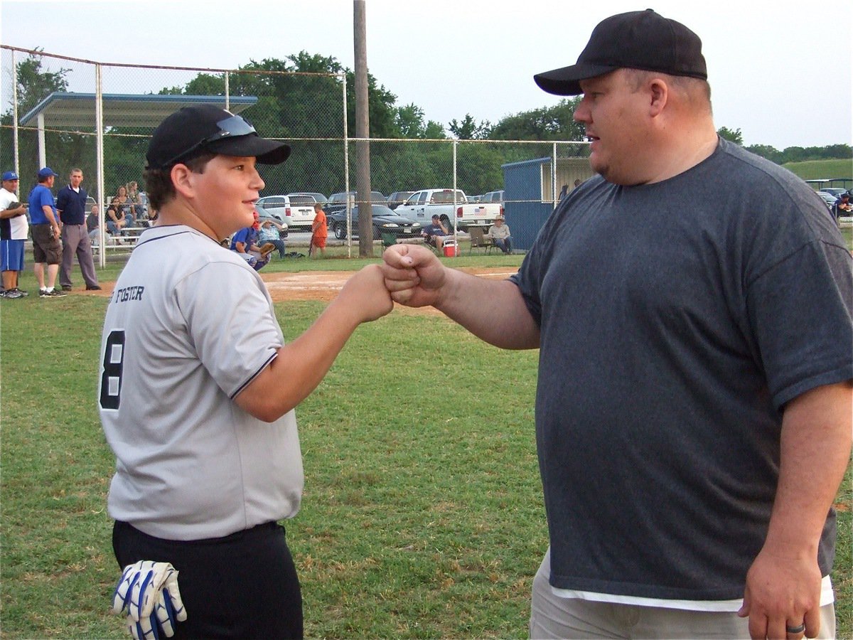 Image: “Let’s do this.” — John Byers and coach Lewis Essary pump each other up before the game.