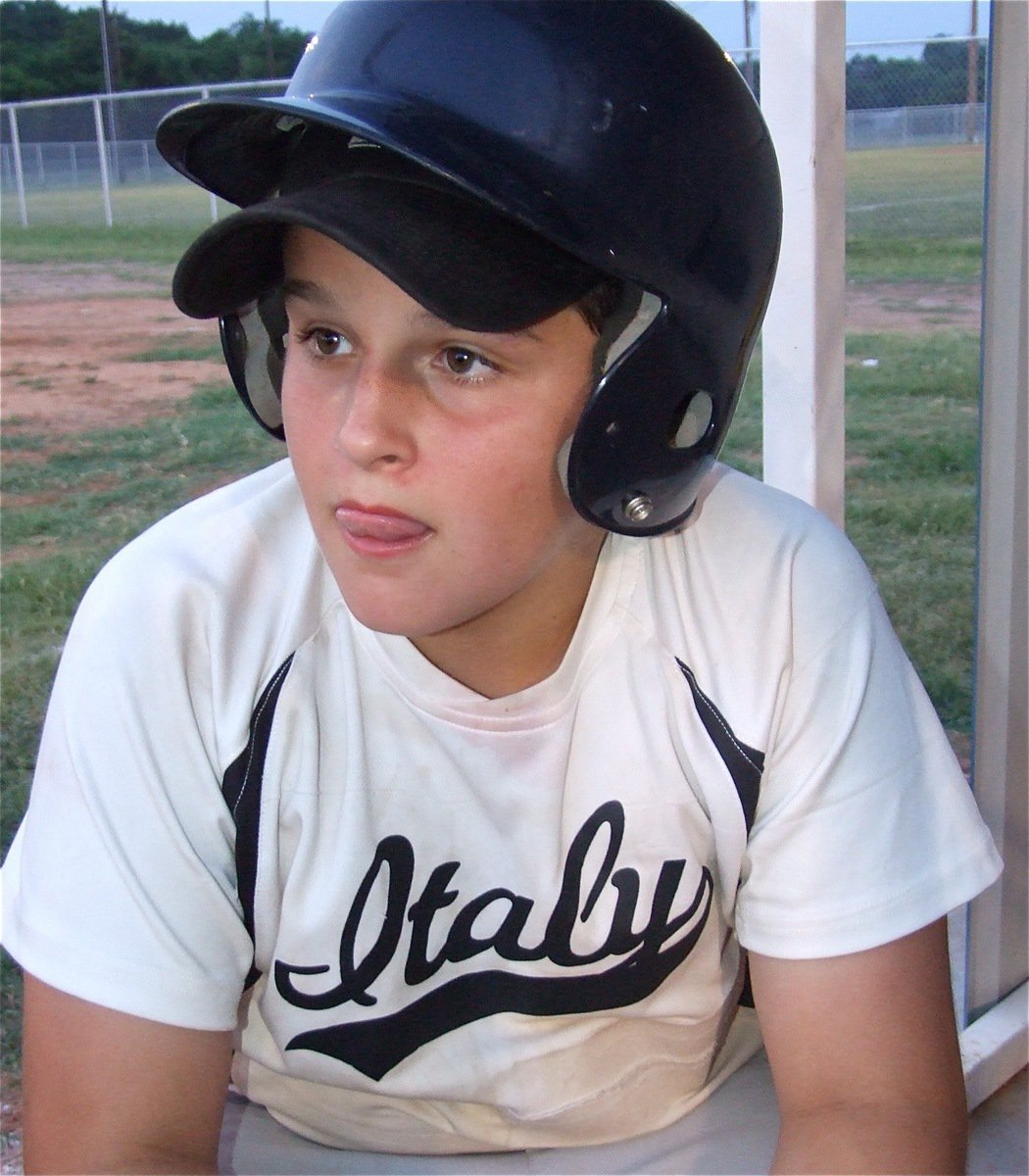 Image: A job to do — Tyler Fedrick pitches in as bat boy during the game between the Gladdogs and Whitney.