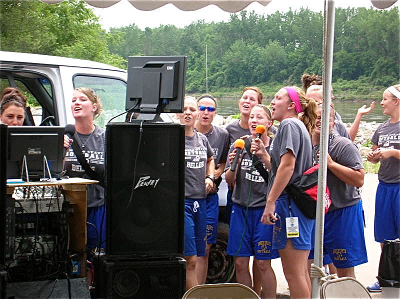 Image: On a high note — Sarah DeMoss, third from left, and her Angelo State Lady Rambelles softball team tests their singing voices in St. Joseph Missouri in an effort to start their National Championship run on a high note.