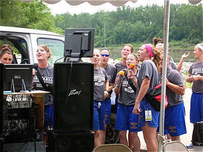 Image: On a high note — Sarah DeMoss, third from left, and her Angelo State Lady Rambelles softball team tests their singing voices in St. Joseph Missouri in an effort to start their National Championship run on a high note.