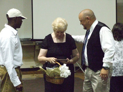 Image: The gold lining — Desmond Anderson and Coach Craig Bales present Bertie Bell Gladiator Fan of the Year treats.