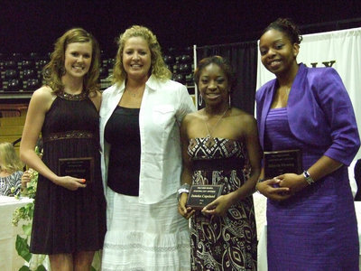 Image: Ladies of glory — Varsity basketball winners: (L-R) Kaitlyn Rossa, Coach Stacy McDonald, Jameka Copeland and Jaleecia Fleming.