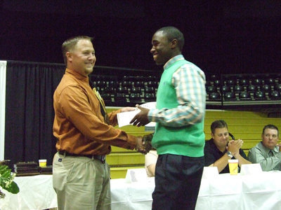 Image: Happiness is another award — Coach Josh Ward presented Jasenio Anderson with his certificate.