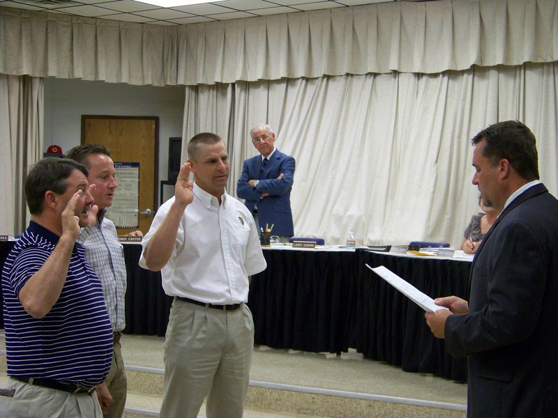 Image: Trustee Oath — Jackie Miller Jr. swears in newly elected board members — Larry Eubank, Jon Mathers and Curtis Riddle.
