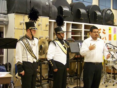 Image: Band Uniforms — Chase Hamilton and Taz Martinez model band uniforms at the monthly meeting of the Italy School Board. Jesus Perez, band director, explains uniform changes to school board members.