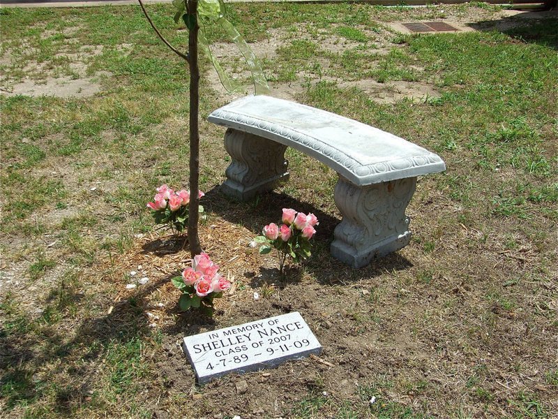 Image: Shelley’s Garden — Marked by an engraved stone and offset by a decorative bench, the Shelley Nance Memorial Garden reminds us to live life and follow your dreams.  The bench was donated by Mrs. Marjorie Bridge, Shelley’s High School Biology Teacher.