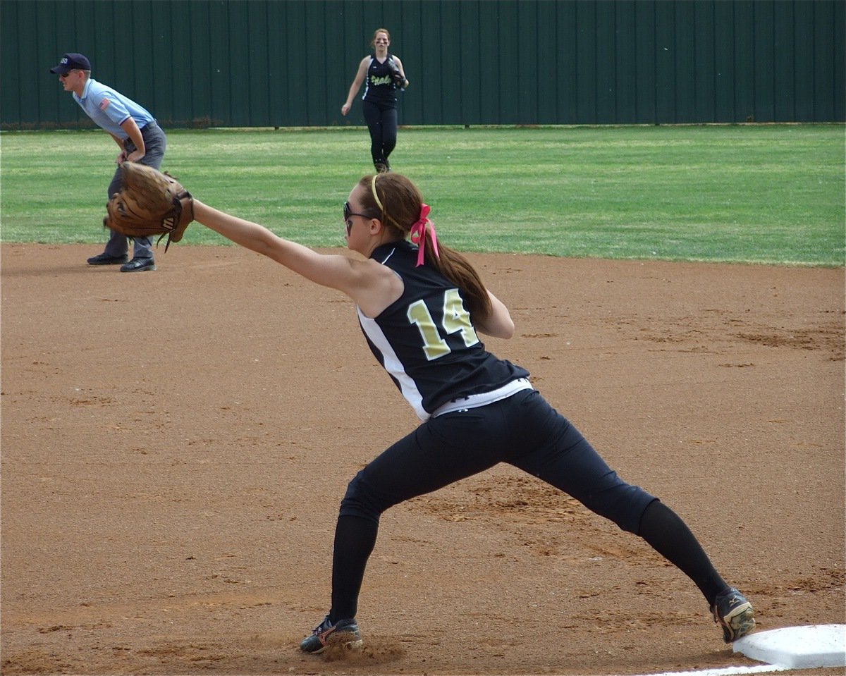 Image: No problem — Senior first baseman Drew Windham(14) stretches out to secure the out. Windham was a First Team All-District selection for the Lady Gladiators a year ago and is expected to be again this season.