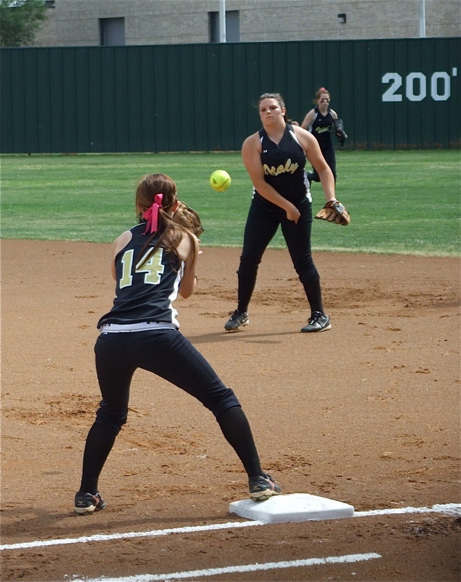 Image: Having nightmares — Senior Cori Jeffords throws to first baseman Drew Windham(14) beating a Meridian runner to the bag. Jeffords and Windham connected nine times throughout the series ensuring that Meridian’s players will have nightmares about the duo for months to come.