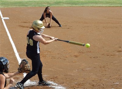 Image: Bailey connects — Bailey Bumpus(18) drives one off the end of her bat against the Lady ’Jackets.