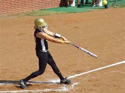 Image: Megan singles — Megan Richards drops one into shallow centerfield for a single.