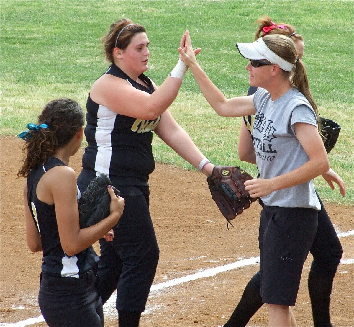 Image: Good job, Merbear! — Italy head softball coach Jennifer Reeves congratulates Meredith Brummett on making the running catch in left field.