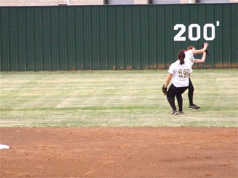 Image: Great grab — Center fielder Bailey Bumpus makes another great playoff grab early in game one against Meridian as second baseman Cori Jeffords(15) wisely pulls back at the last moment.
