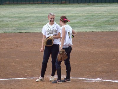 Image: Senior management — Senior first baseman Drew Windham(14) consults with senior pitcher Courtney Westbrook(10) on the mound in Joshua. Lady Gladiators Softball, Inc. is officially in business.