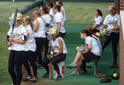 Image: Into the game — The Lady Gladiator dugout keeps their eyes on the action.