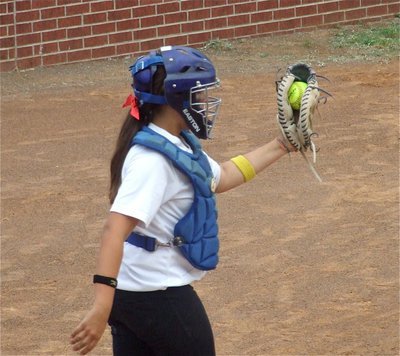 Image: Strike three on display — Catcher Alyssa Richards displays the strike three thrown by pitcher Courtney Westbrook since the Meridian batter missed it the first time it passed by.