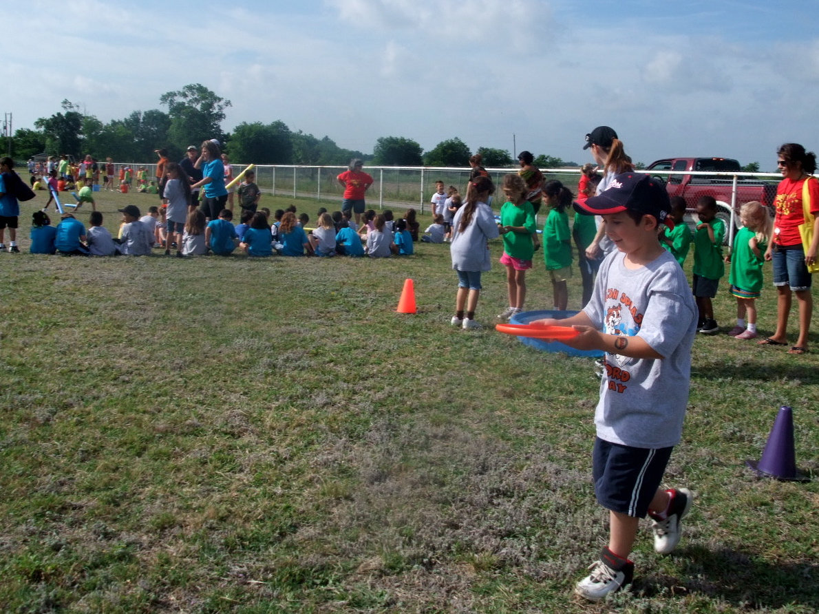 Image: Frisbee Water Race — The idea of this race is to walk as fast as you can without spilling the water out of the frisbee and hand it off to your partner.