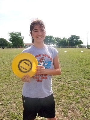 Image: Kaci Bales — Kaci Bales, another sixth grader, was helping with the game “Target Frisbee” and she explained the way the game was played, “You throw a frisbee and where ever it lands it becomes the target and you throw a ball and whoever gets nearest to the frisbee wins.”