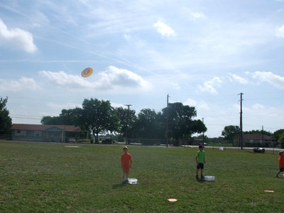 Image: Splash Flyers — To play this game you get the frisbee wet and you throw it to your partner and they throw it back to you and you try to catch it.