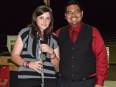 Image: Alexis &amp; Mr. Perez — 7th grader Alexis Sampley, a 1st chair oboe player, receives a medal from IHS Band Director Jesus Perez.