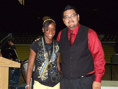 Image: Kortnei &amp; Mr. Perez — Kortnei Johnson, a 1st chair flute player in the 7th grade Band, receives a medal from Band Director Jesus Perez recognizing her efforts.