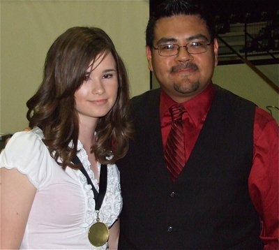 Image: Meagan honored — 8th grader Meagan Hooker receives a 1st chair medal from Jesus Perez. Hooker is a 1st chair flute, All-Region MS and Central Texas Honor Band member.