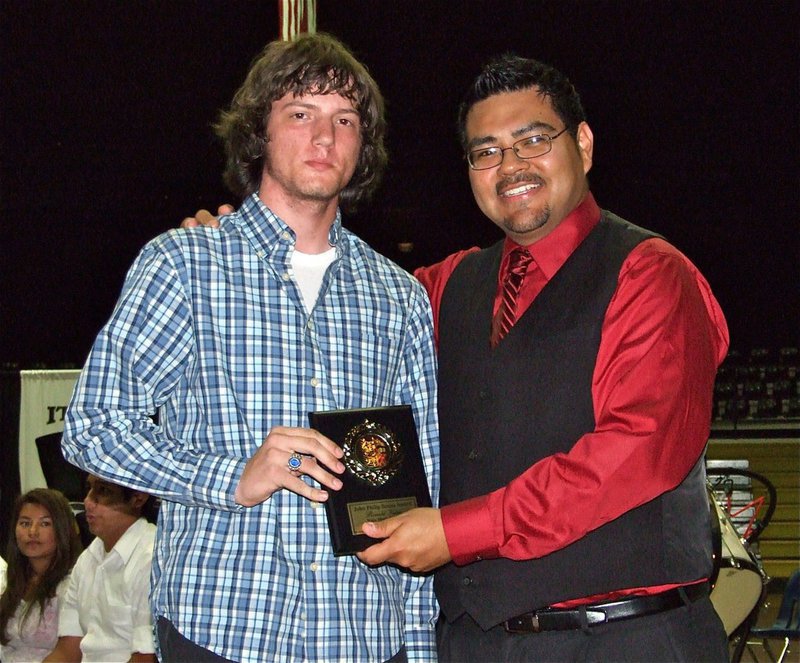 Image: Ronald Helms — Gladiator Regiment Band member and graduating senior Ronald Helms accepts the John Phillip Sousa Award from Mr. Perez. Helms is a 1st chair saxophone player, a Tri-M member, an All-Region Jazz selection and All-Area Jazz selection this year.