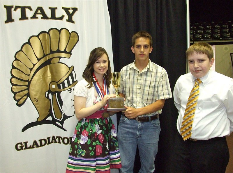 Image: Meagan Hooker, Cody Medrano and Brett Kirton — Brett Kirton, the 2009 Oliphant Cup recipient, presents the 2010 recipients, Meagan Hooker and Cody Medrano, with the Oliphant Cup during the Italy Junior High Honors Assembly on Wednesday.