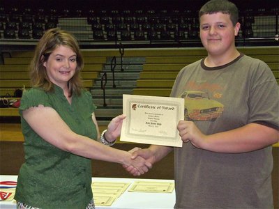 Image: Zachary Mercer — Zachary Mercer is honored with a Certificate of Award from IHS Principal Tanya Parker for Highest Average in Tech App.