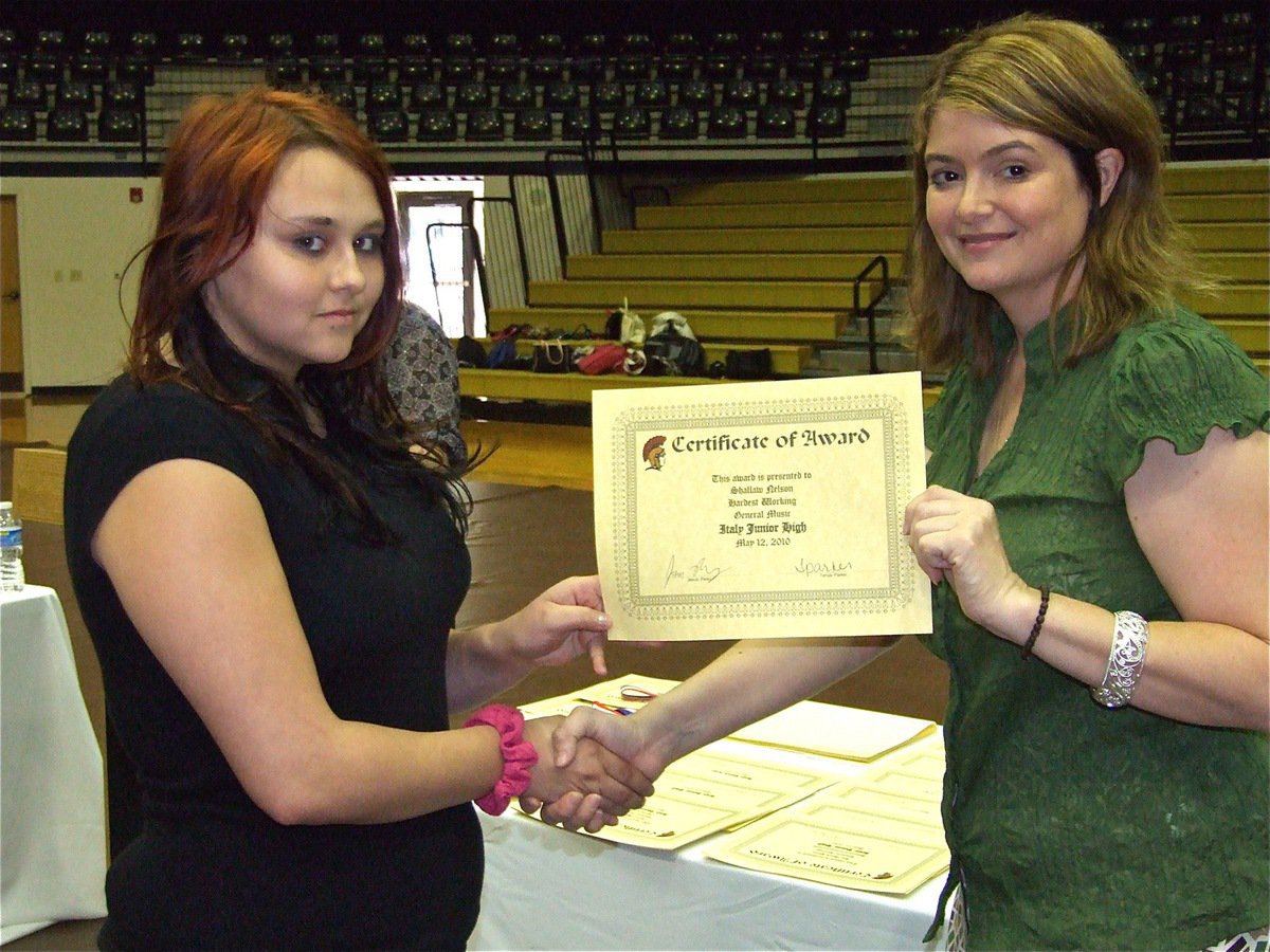 Image: Shallaw Nelson — Shallaw Nelson is honored with a Certificate of Award from IHS Principal Tanya Parker for Hardest Working in General Music.