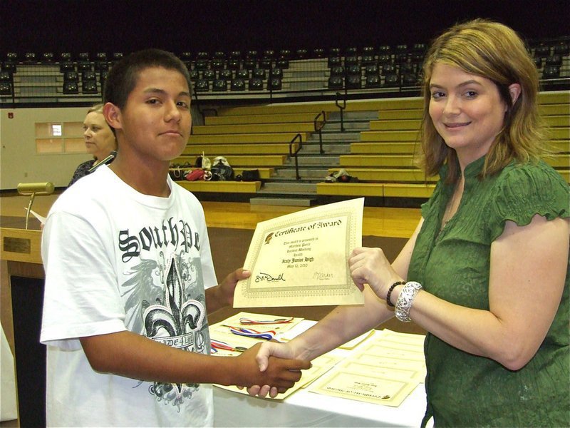 Image: Matthew Parra — Matthew Parra is honored with a Certificate of Award from IHS Principal Tanya Parker for Hardest Working in Health.