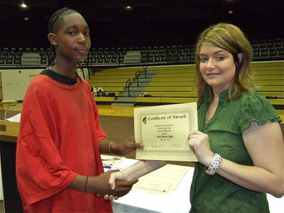 Image: Trevon Robertson — Trevon Robertson is honored with a Certificate of Award from IHS Principal Tanya Parker for Hardest Working in English.