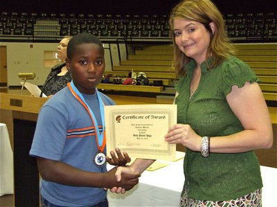 Image: Dominic Wilson — Dominic Wilson is honored with a Certificate of Award from IHS Principal Tanya Parker for Citizenship in English.