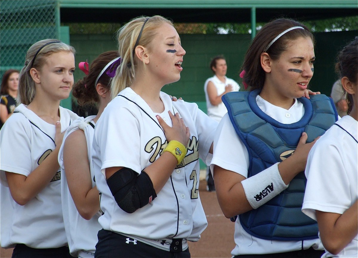 Image: Sing it proud, Meg! — Courtney Westbrook, Drew Windham, Megan Richards and Alyssa Ricahrds stand with their team during the playing of the National Anthem before the start of the game against Hubbard Tuesday evening.