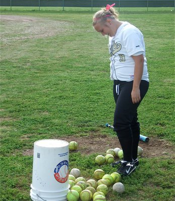 Image: So many balls… — …so little time. Drenda Burk gets in some batting practice before the game against Hubbard.