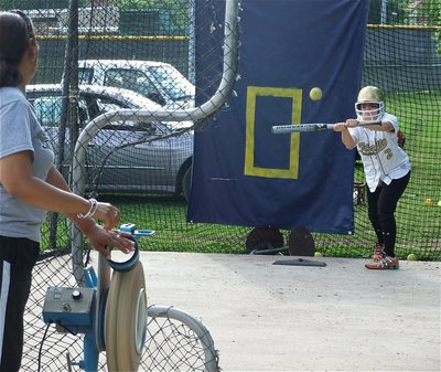 Image: Casi in the cage — Casi Jeffords works on her bunt technique in the batters cage with coach Tina Richards.