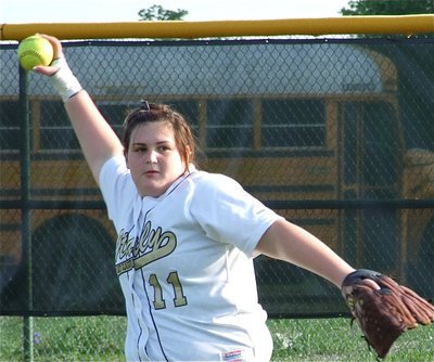 Image: Meredith throws — Meredith Brummett makes a throw from left field.